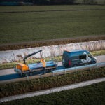 Rail Raise 100 Towed by a Van installing highway guardrail